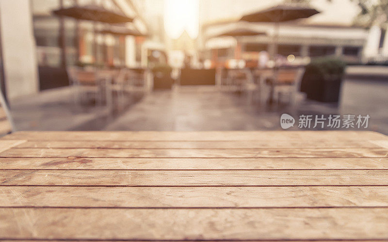 Empty wood table and blurred cafe with bokeh light background